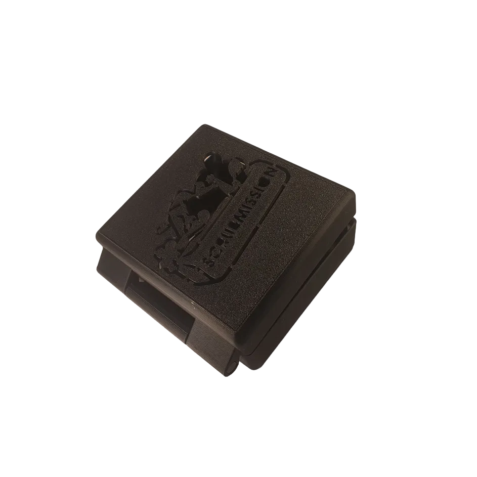 Black square plastic component with branding on a white background