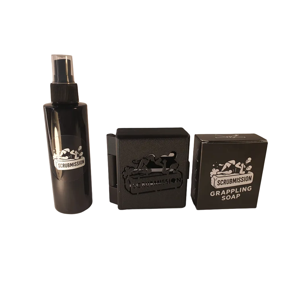 Set of Scrubmission products including a spray bottle and soap bars on a white background