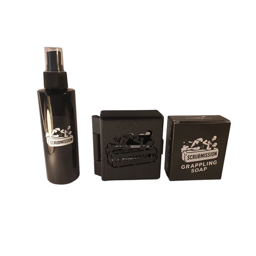Set of Scrubmission products including a spray bottle and soap bars on a white background