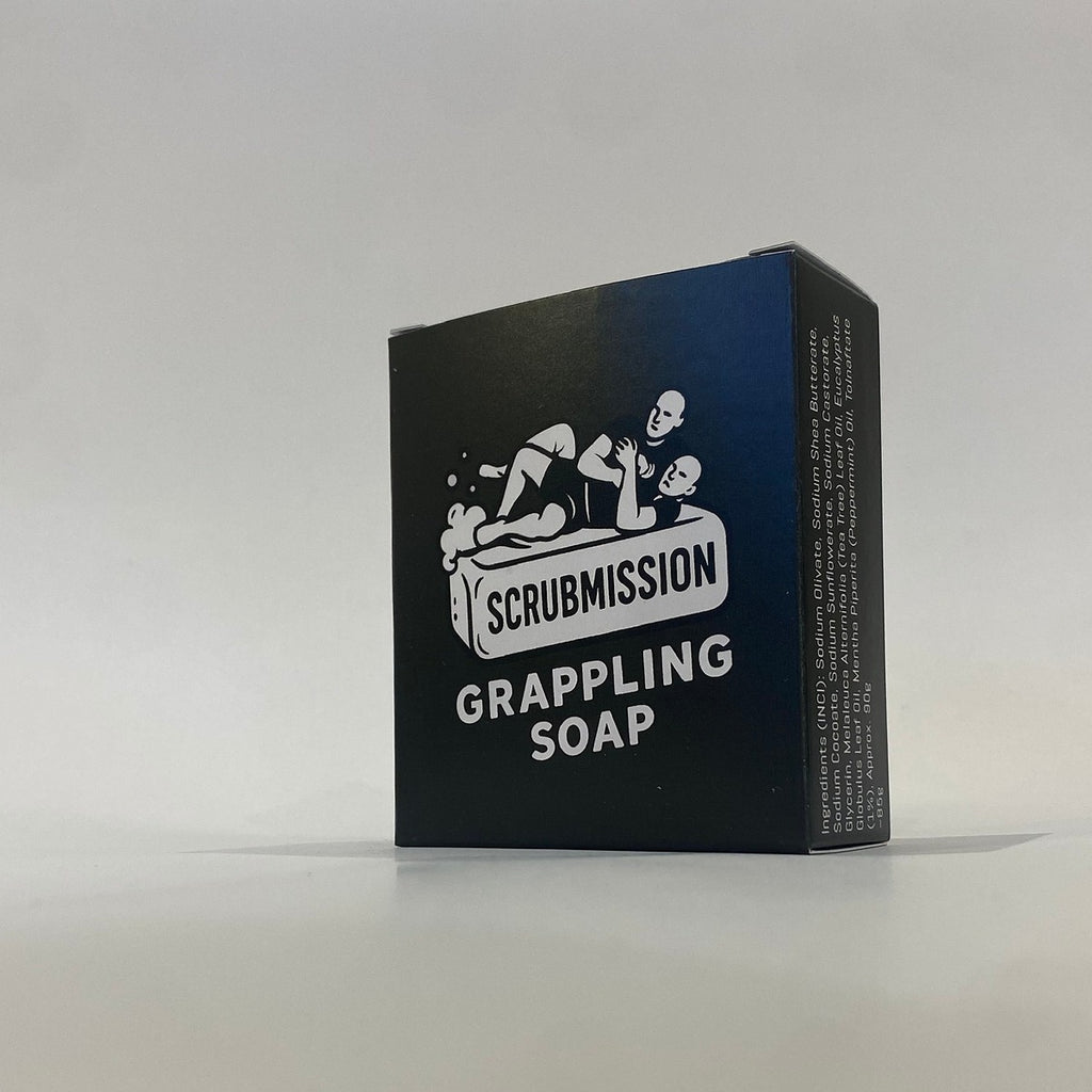 Scrubmission Soap bar stacked with fresh peppermint leaves and eucalyptus sprigs for a refreshing vibe.