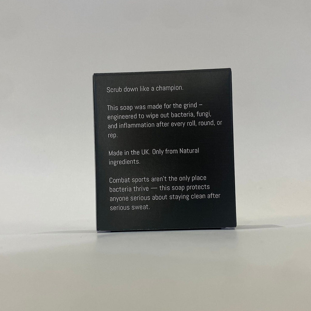Black soap packaging with white text on a light gray background