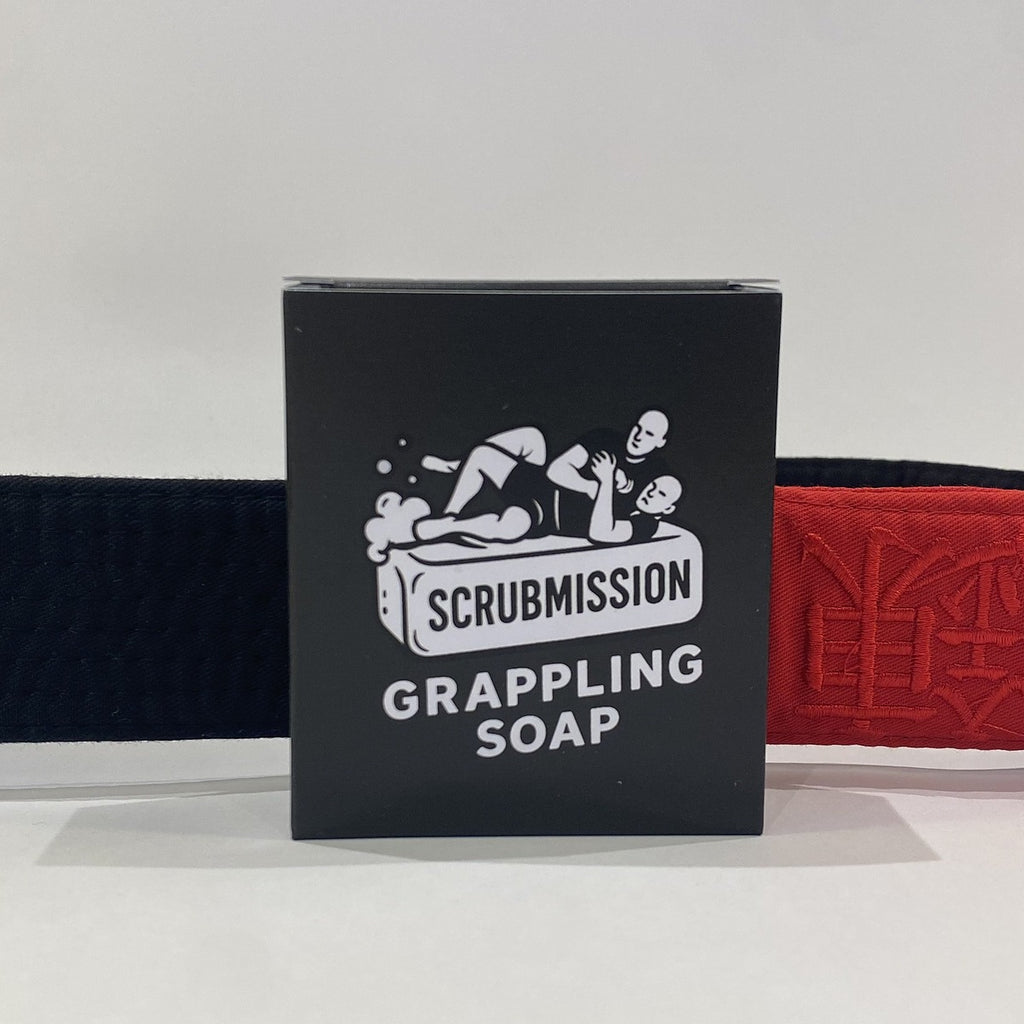 Scrubmission grappling soap packaging with black belts on a white background