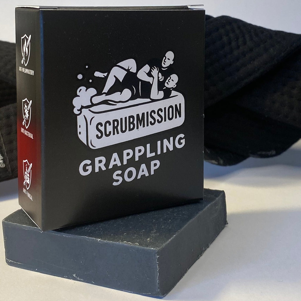 Athletic lifestyle photo of Scrubmission Soap with BJJ gi and gym equipment, emphasizing its use for grapplers.
